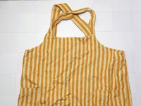 the minna apron on a white tile surface
