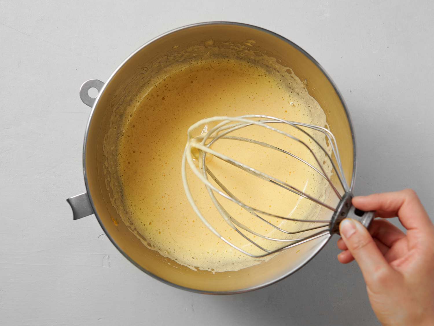 Eggs, sugar, and salt whipped in a bowl until mixture is lightened and pale in color 