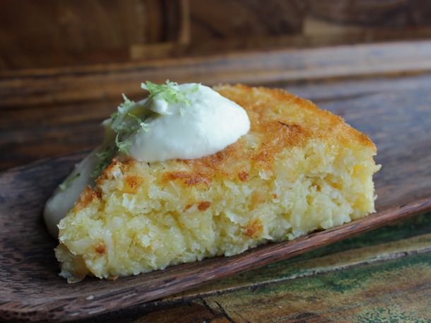 Flourless Bitter Lime Coconut Macaroon Cake, served on a wooden board.
