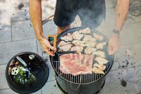 Meat is cooked in the Weber Smokey Mountain Cooker 18-Inch Charcoal Smoker (721001)