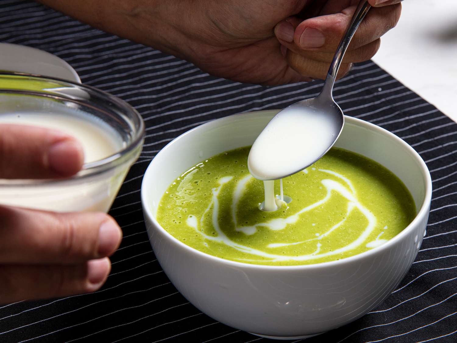 Cream being added to garlic scape soup 