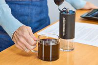 A cup of coffee with beans ground in the Comandante C40 Nitro Blade Grinder