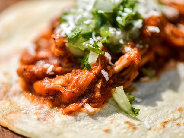 Close-up of the chicken tinga on a tortilla.