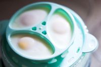 A closeup of poached eggs in the Dash egg cooker
