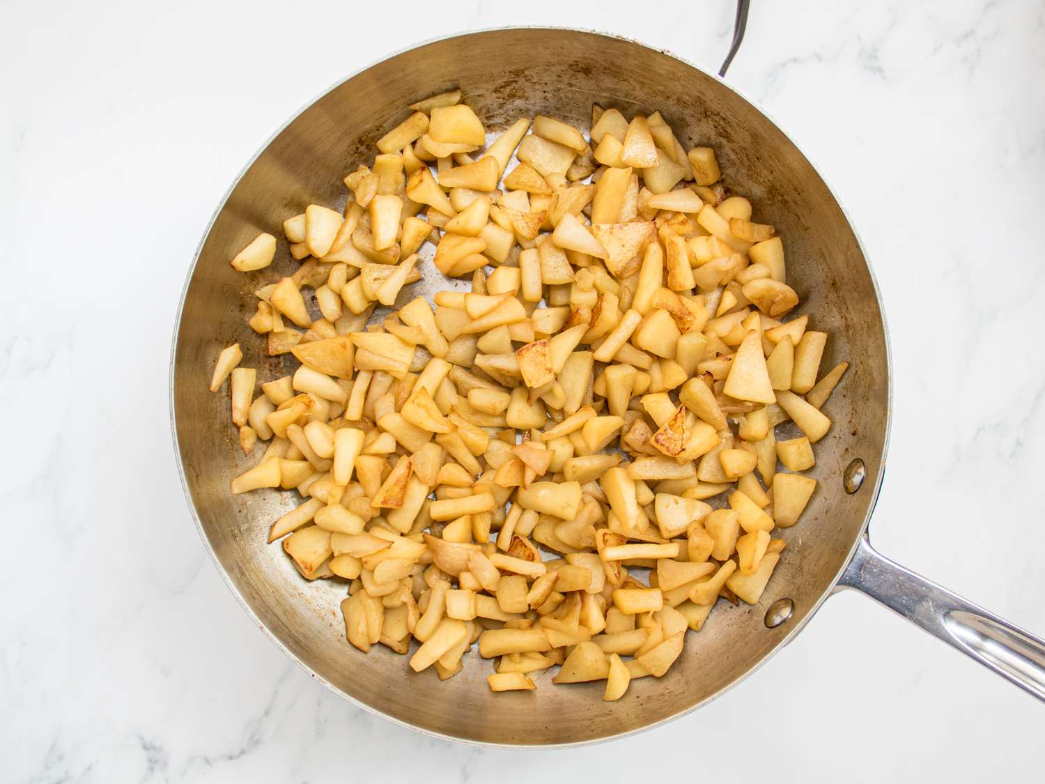 Overhead view of apples cooking in pan