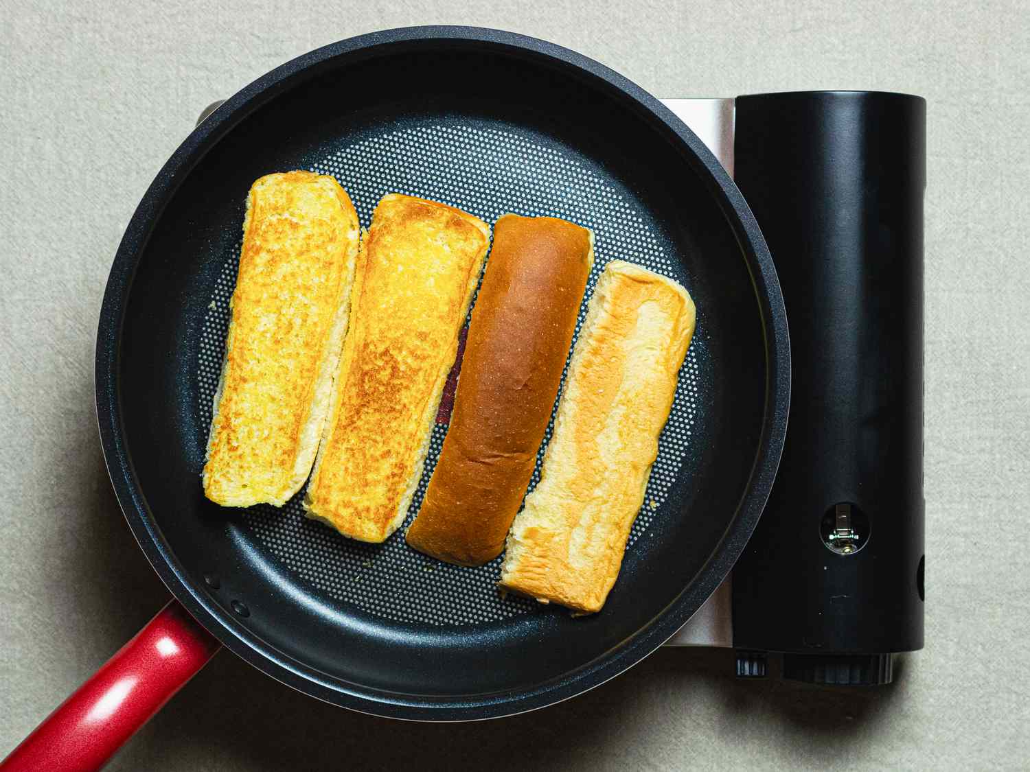 Overhead view of buns being toasted
