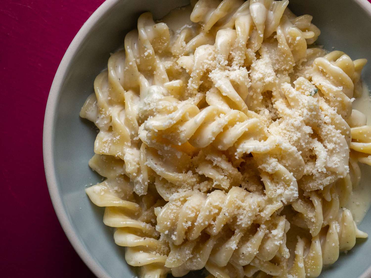 The finished pasta, served in a bowl and sprinkled with grated Parmigiano Reggiano.