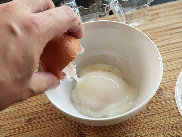 Sous vide poached egg cracked in a bowl