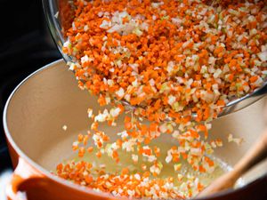 Diced vegetables being added to a pot