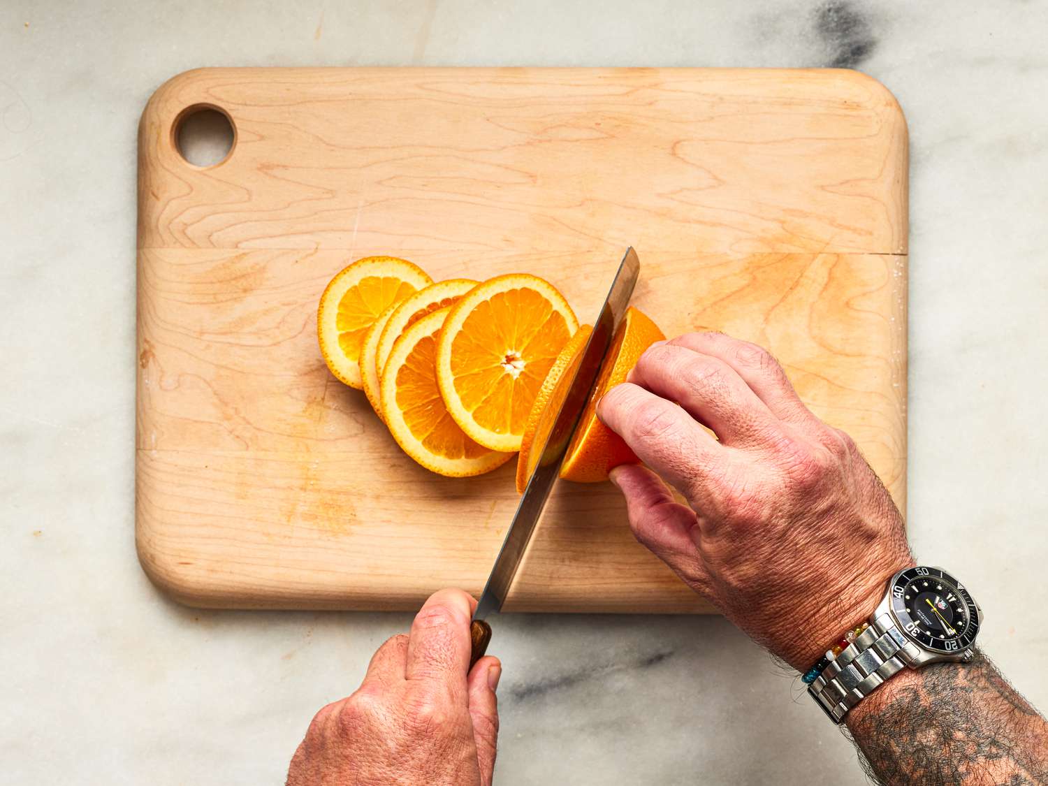 Overhead view of slicing oranges