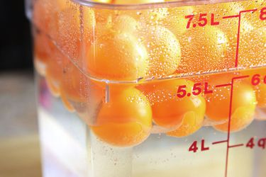 A sous vide bath covered in ping pong balls.