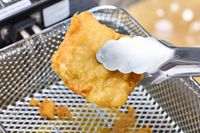 A piece of fried food cooked in the All-Clad Easy Clean Pro 3.5L Electric Deep Fryer