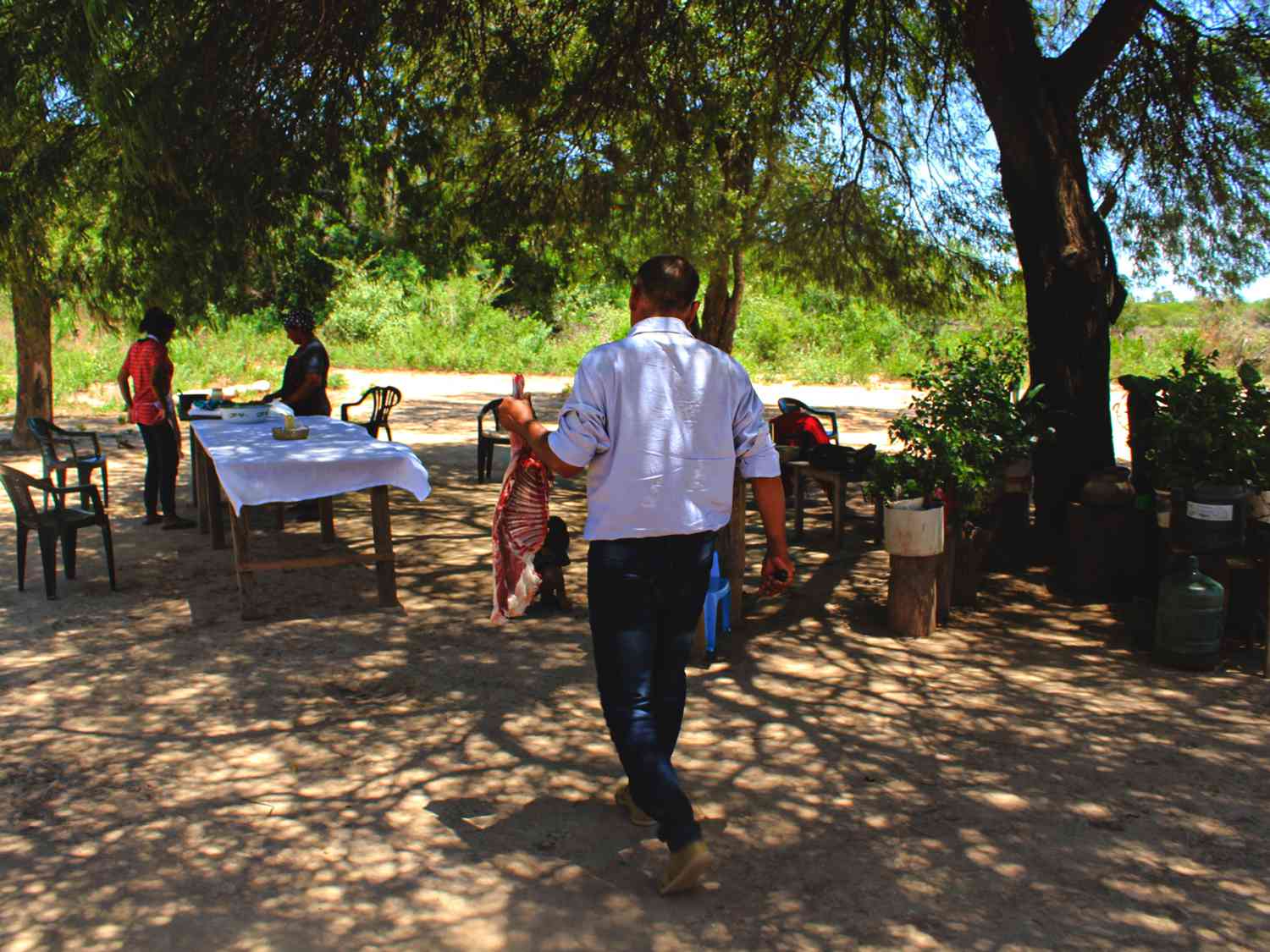 Jorge Luna carries a freshly butchered goat