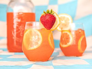 Strawberry lemonade in two glasses and a pitcher