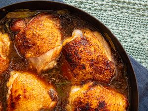 Cooked chicken thighs in a pan