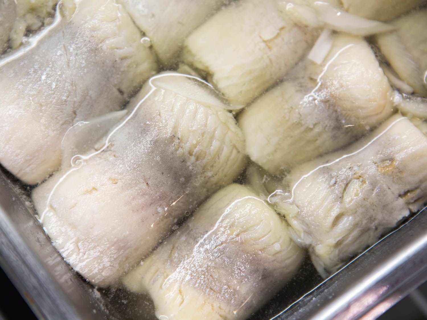 Closeup of rolled pickled herring fillets.