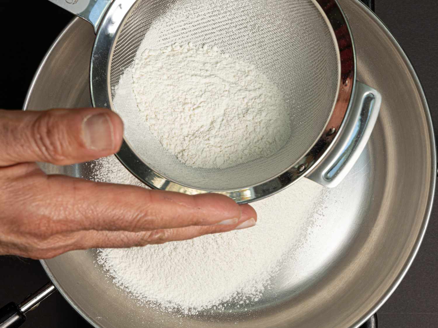 Overhead view of shifting flour