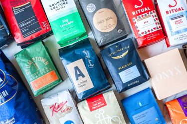 A variety of espresso coffee bags from different brands arranged side by side