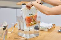 Breville Joule Turbo Sous Vide Machine with vacuum-sealed salmon in a water bath