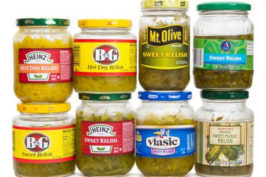 Eight pickle relishes in jars. 