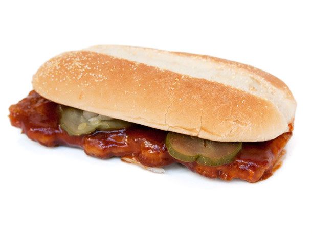 The McDonald's McRib sandwich, topped with pickles on a sub roll.