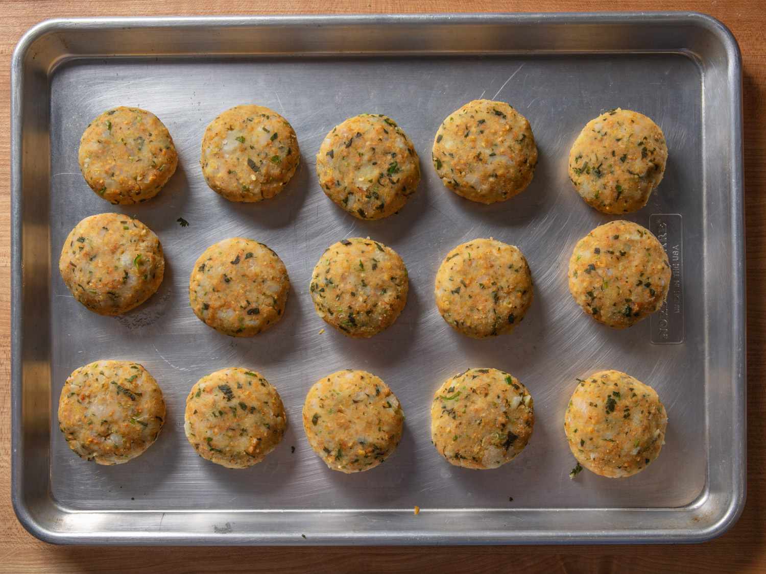 Formed aloo tikki before frying on a rimmed baking sheet
