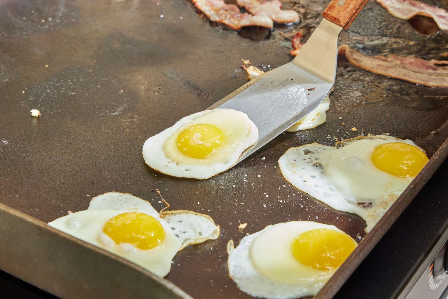 Eggs are cooked on the Blackstone 1554 Cooking 4 Burner Flat Top Gas Grill