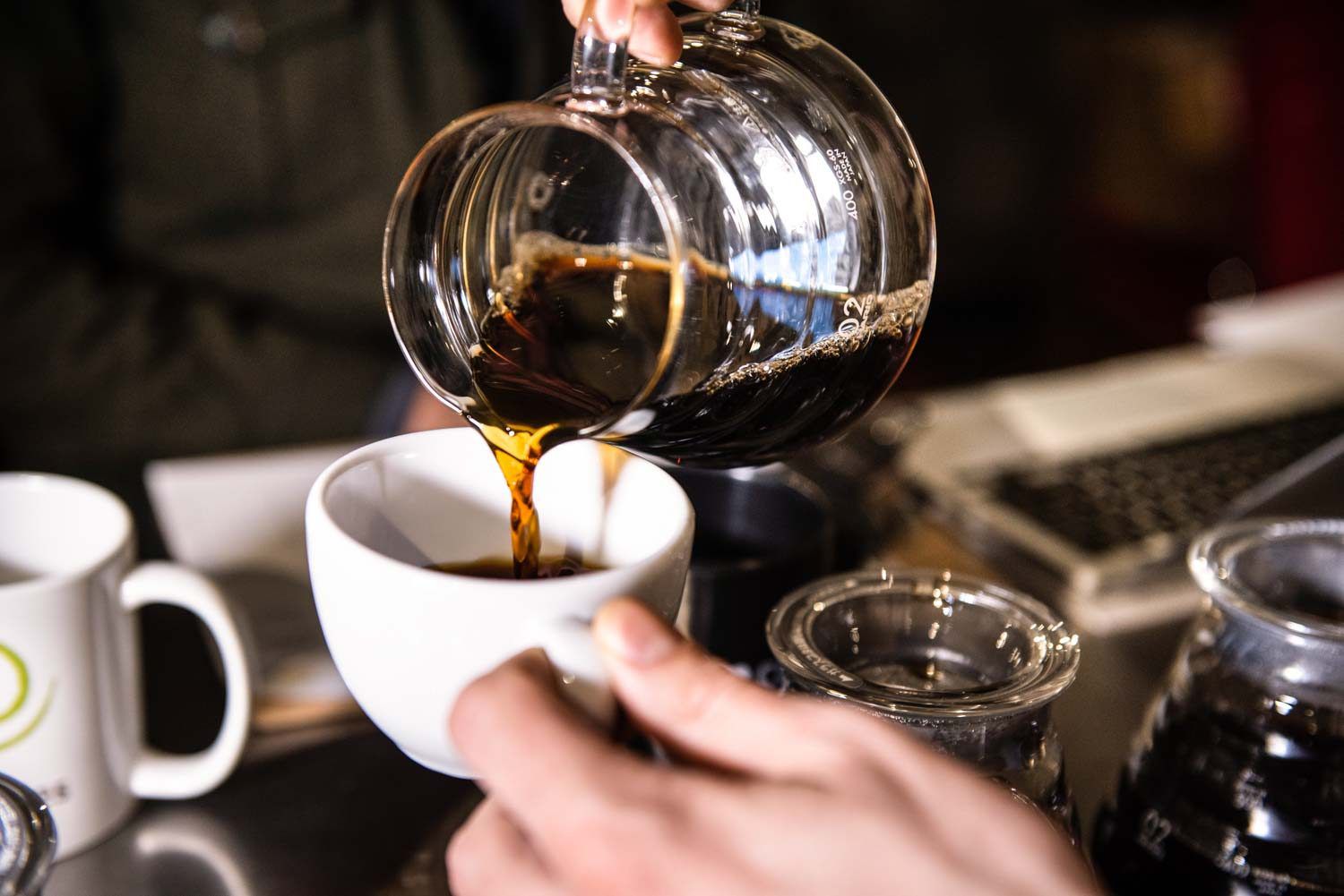 A person pouring coffee into a mug.