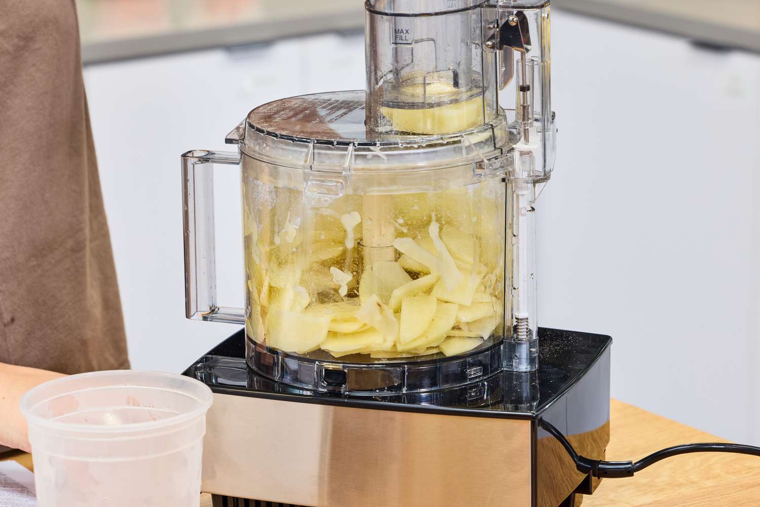 A person chops potatoes in the Cuisinart 14-Cup Food Processor