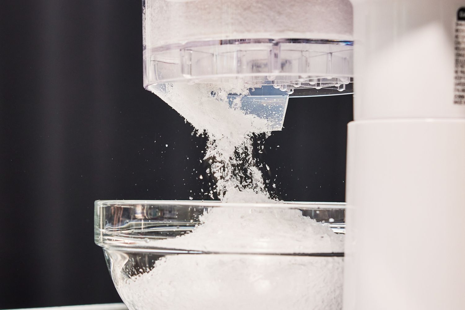a closeup look at a shaved ice machine shaving ice