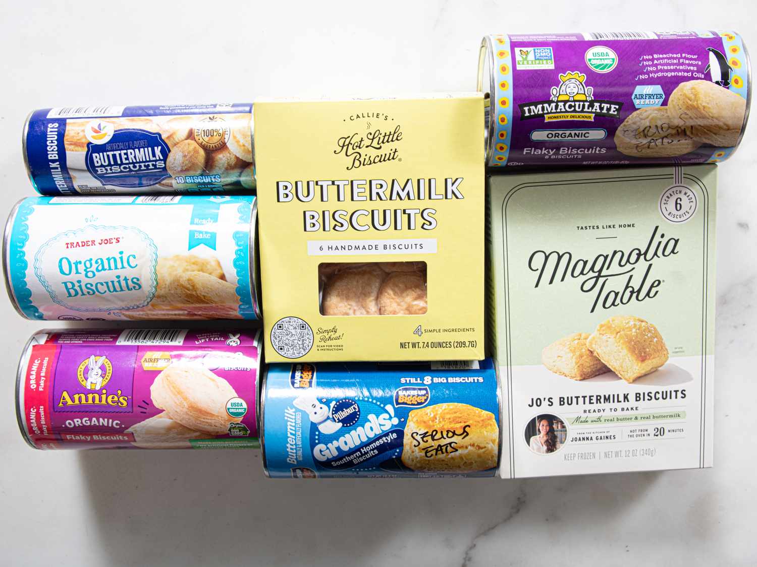 A selection of various biscuit products from different brands arranged on a white surface