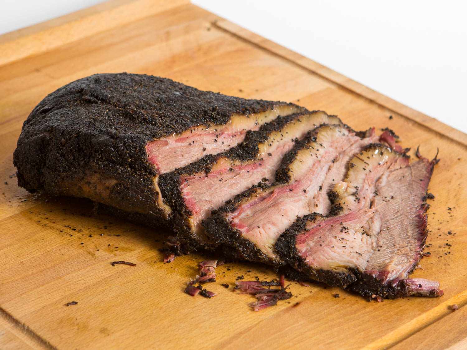 Sliced brisket on a cutting board. 