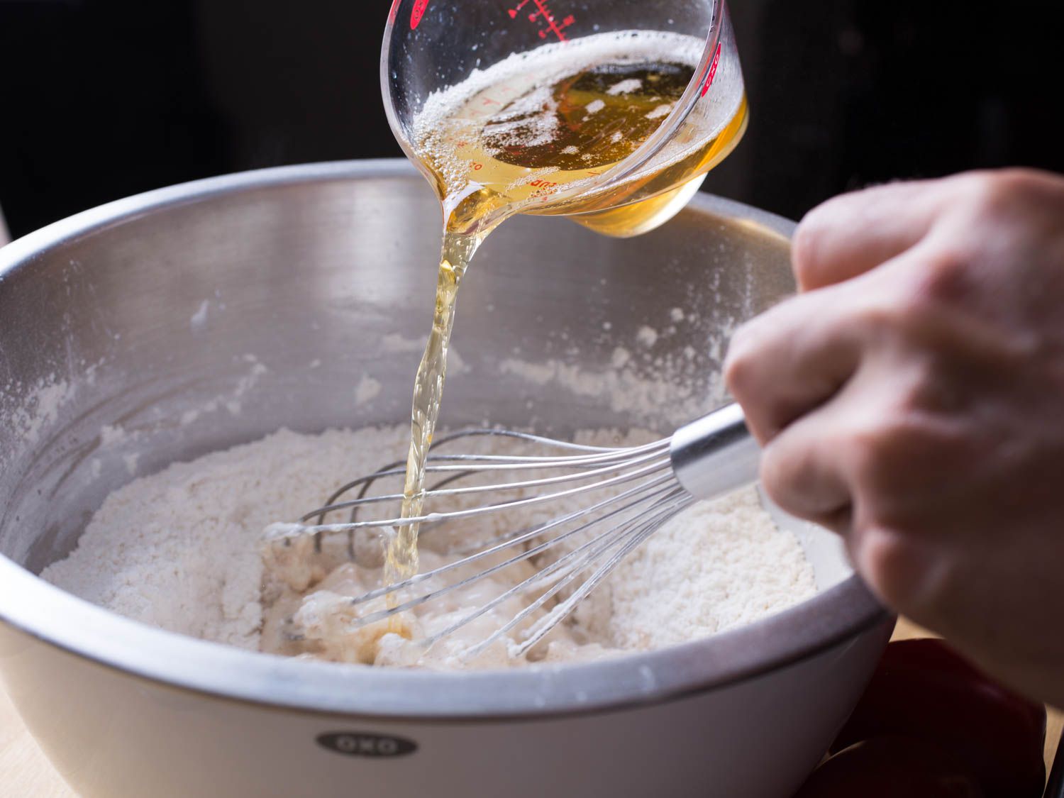 Whisking beer into flour mix to make batter