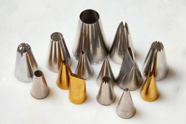 A collection of piping tips of various sizes and shapes.