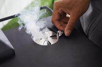 Hand adjusting the smoke release on the Masterbuilt MB20072918 40-Inch Digital Electric Smoker