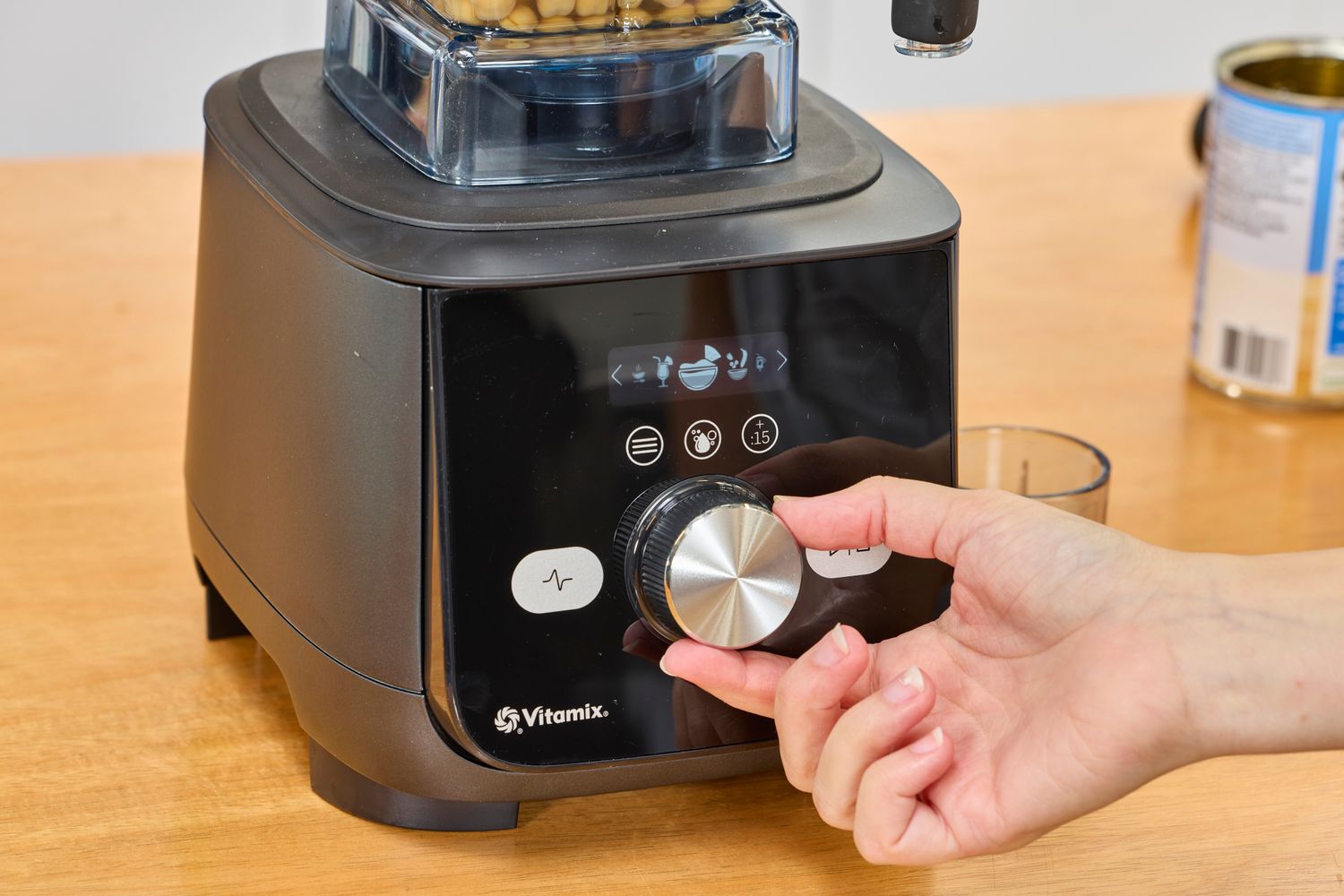 A hand turning a nob on the Vitamix Ascent X5 Blender