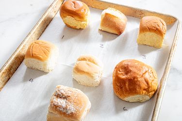 Six dinner rolls on a baking sheet lined with parchment paper numbered 1 to 6