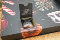 A door to the Lakrids by Bülow Holiday Advent Calendar opened to reveal a bag of licorice