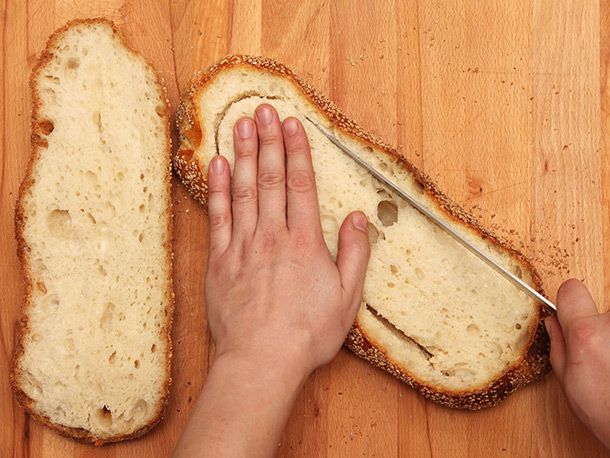 cutting around the inside of the bottom half with serrated bread knife