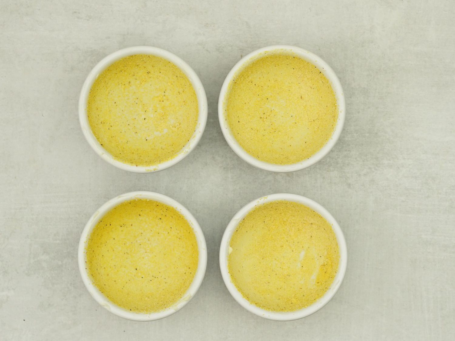 Four greased ramekins.