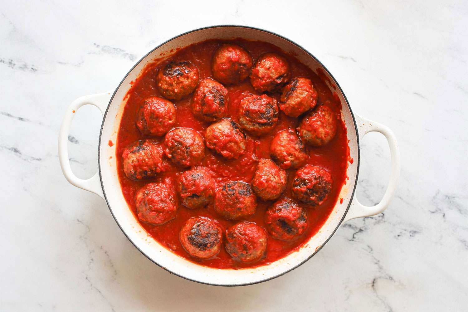 A pot filled with meatballs in tomato sauce