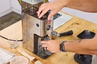 A person adjusts the grind setting on the Lelit William Espresso Grinder