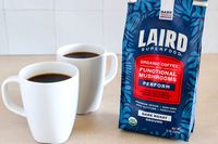 Two cups of coffee next to a bag of Laird Superfood organic coffee with functional mushrooms