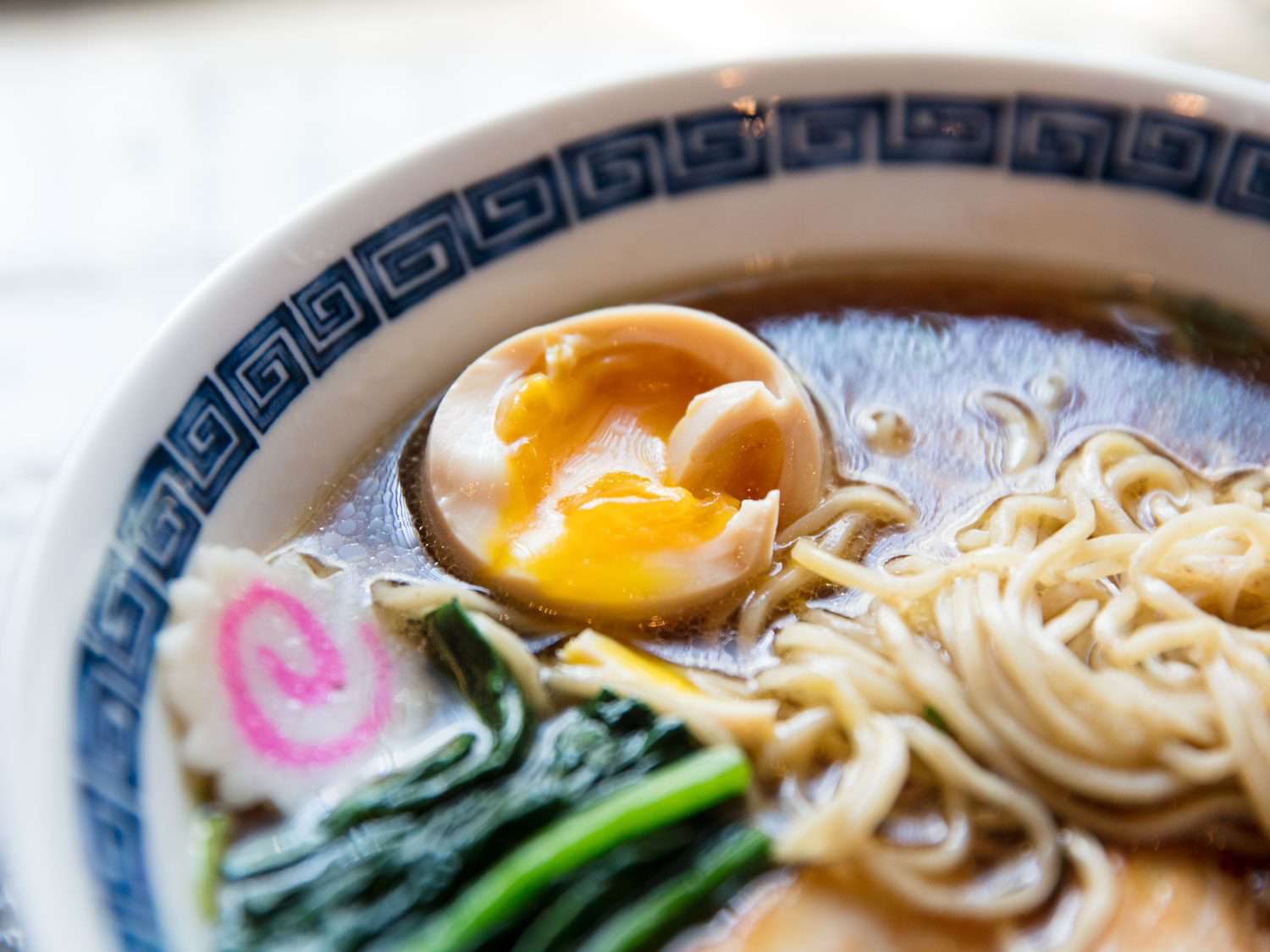 Close up of ajitama egg in shoyu ramen broth, Ramen Shack