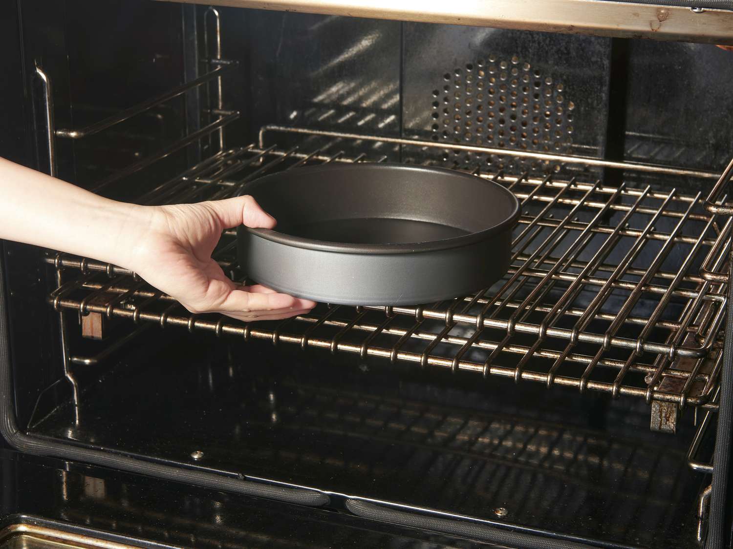 Side view of placing pan in over