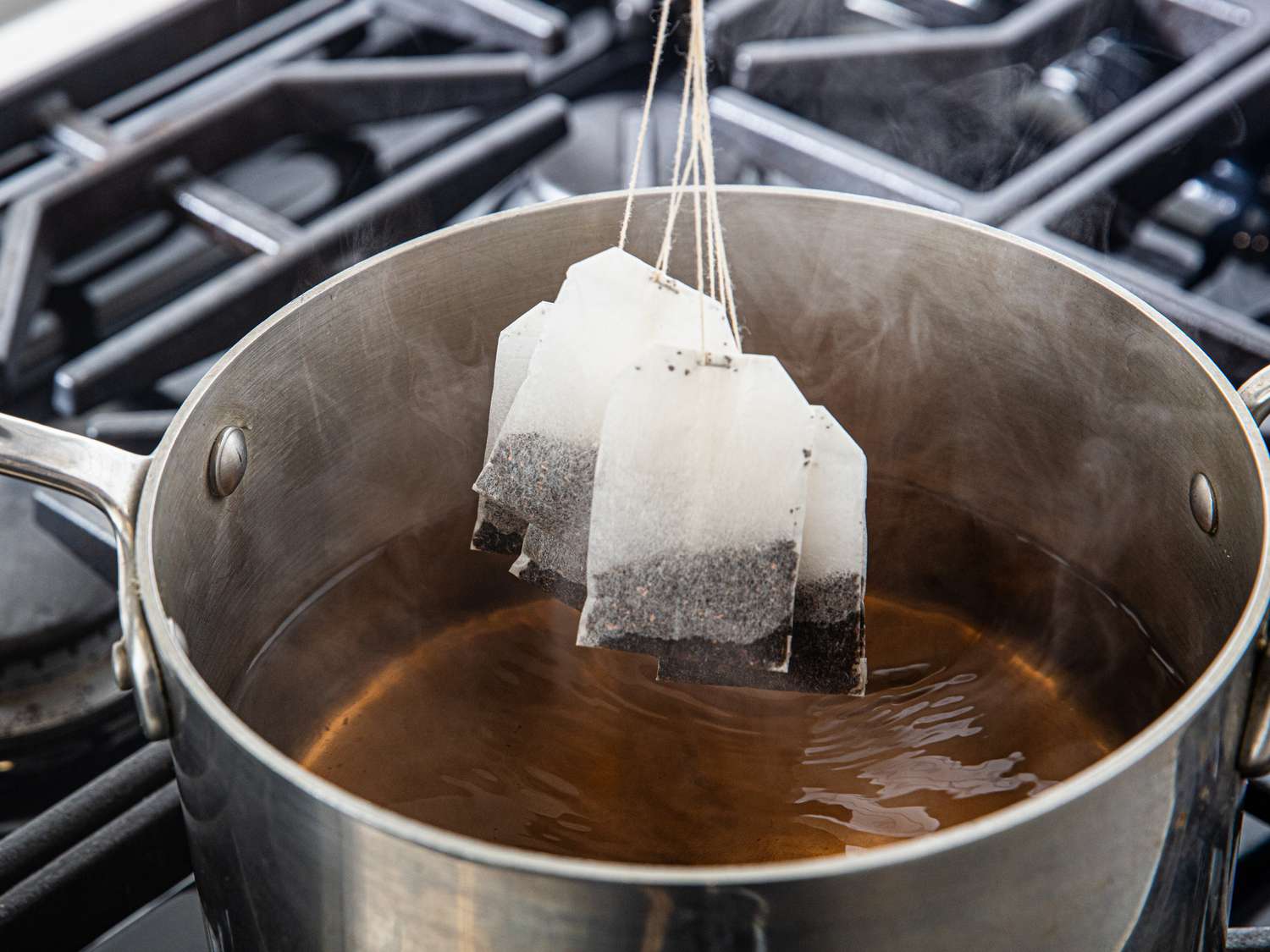 Overhead view of lowering tea bags 