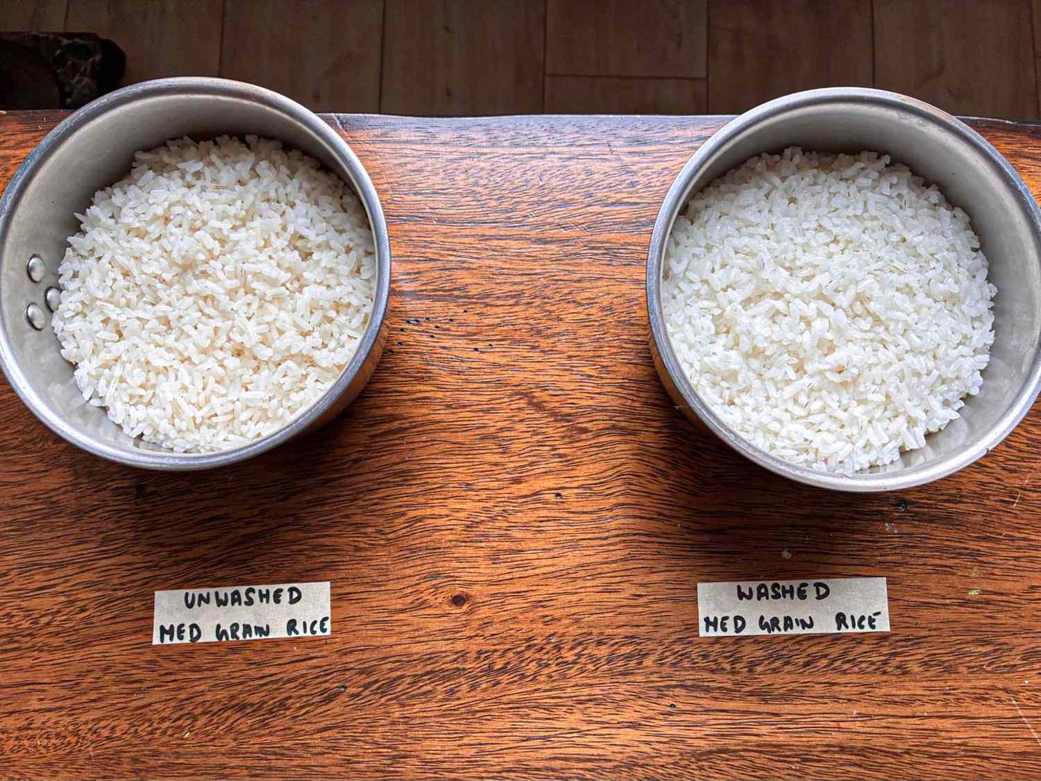 Two bowls of medium grain rice one labeled unwashed and the other labeled washed