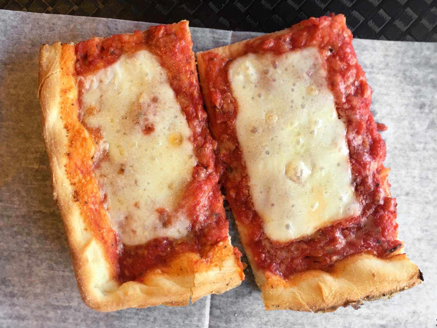 Two rectangular slices from Rizzo's Fine Pizza