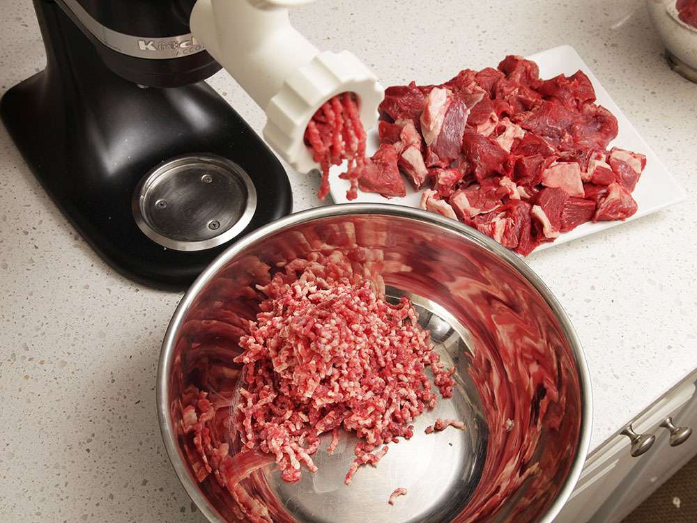 Grinding pieces of bison for burger. 