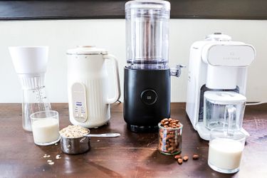 four nut milk makers on a wooden countertop